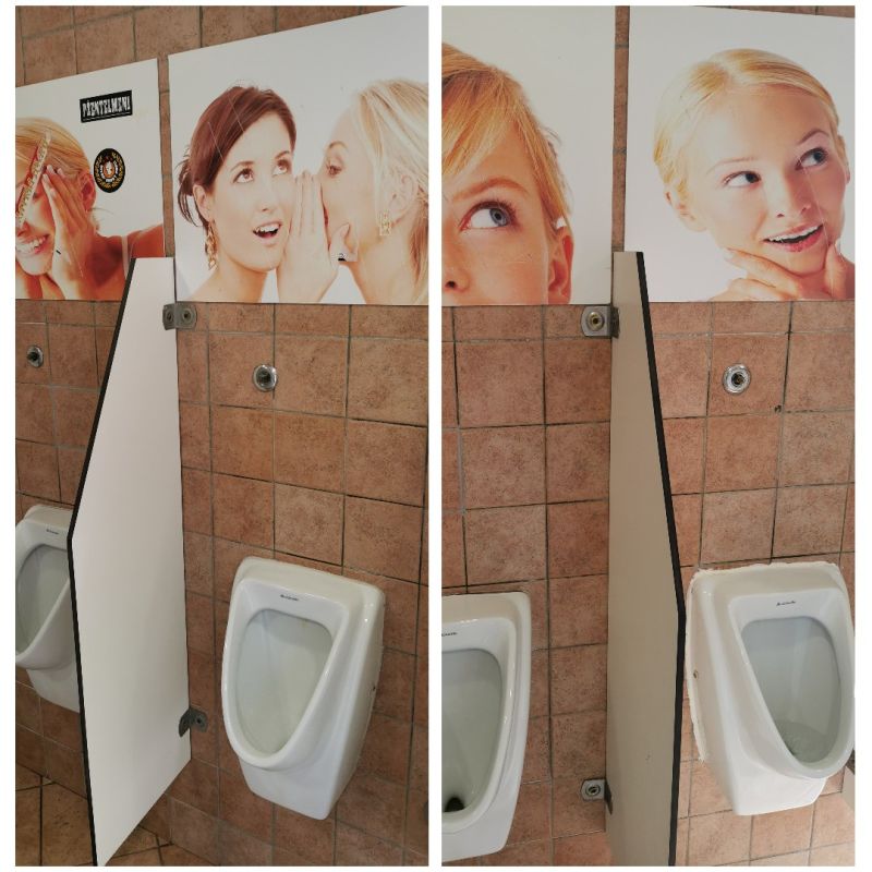 Männertoilette in Slowenien mit Frauenbildern über der Pissoirs.